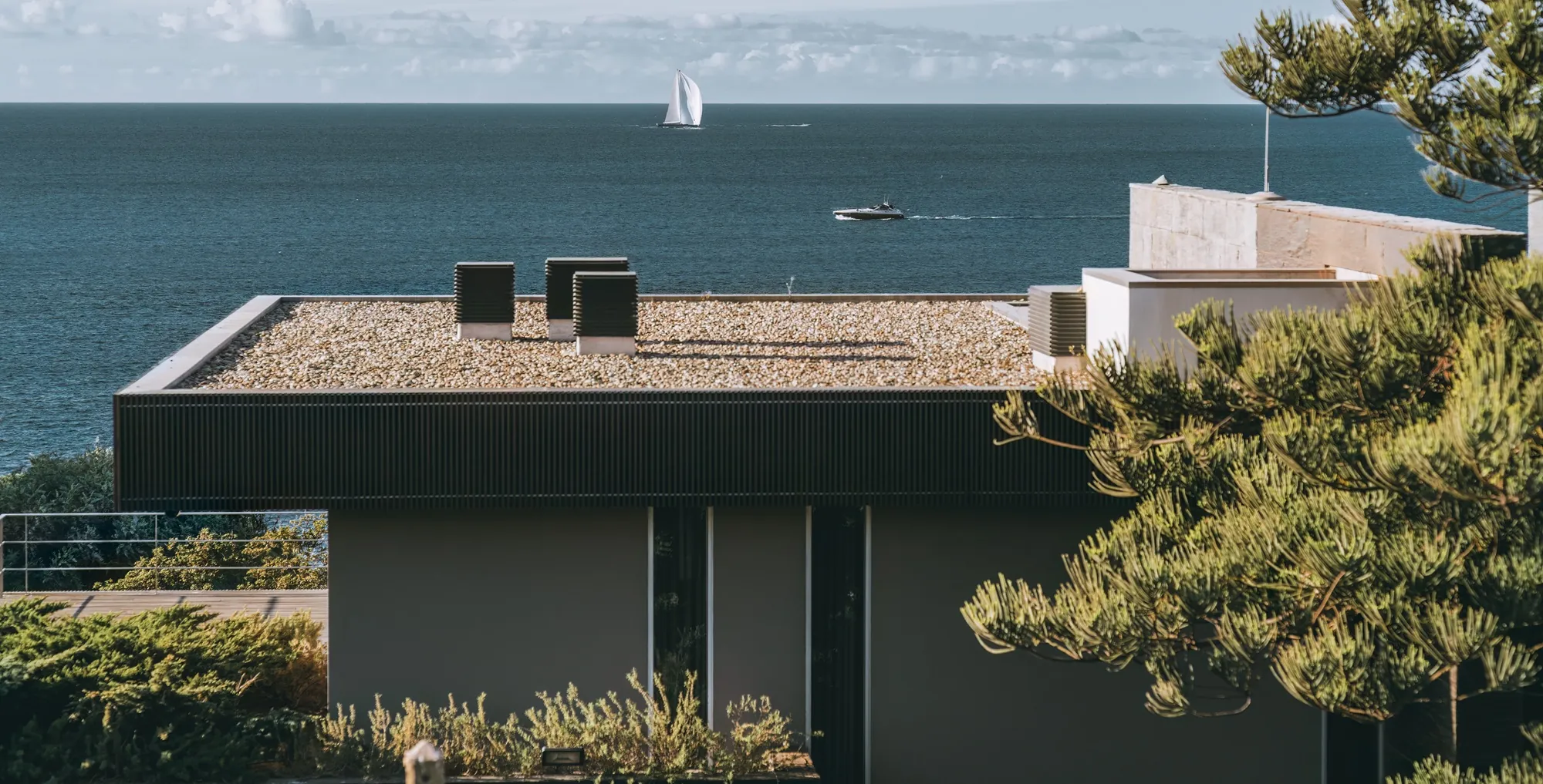 A flat roof on a house with a membrane covering and rainwater outlet